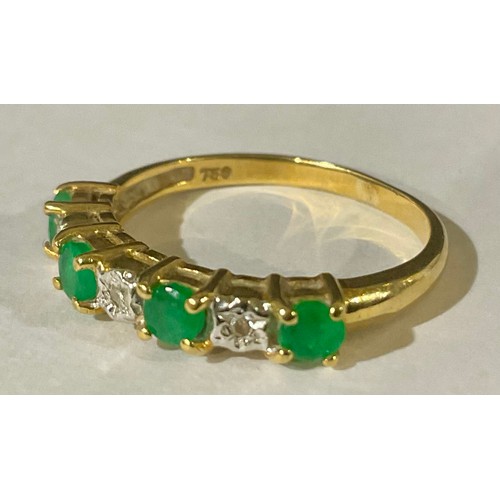 398 - 18ct Gold Emerald and Illusion Set Diamond Seven Stone Half Eternity Ring
The ring is set with four ... 