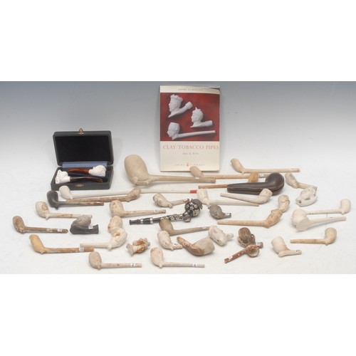 3062 - A collection of 18th century and later clay pipes, including RAOB pipe, Leich & Co; greyhound head b... 