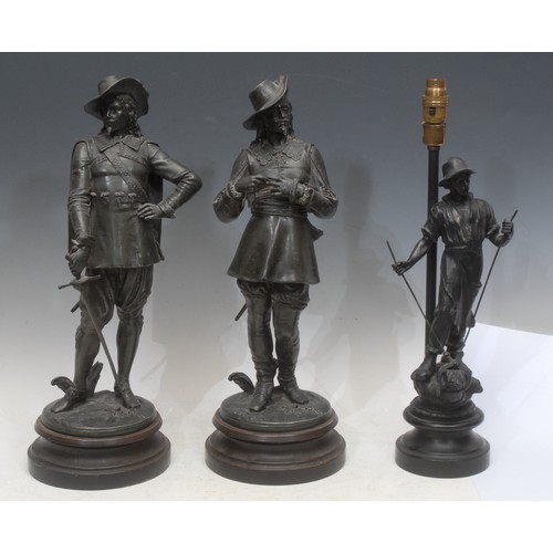 3557 - A patinated bronze effect figural sculpture, of a musketeer with a sword, circular base, 48cm high o... 