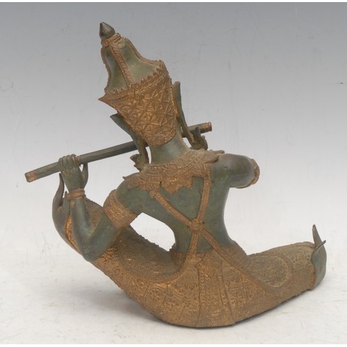 3561 - A Thai Buddhist patinated bronze, cast as a Gandharva (celestial musician) playing a flute, picked o... 