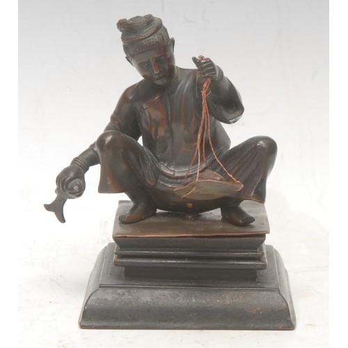 3551 - A 19th century South East Asian bronze, of a fisher-boy weighing his catch, moulded hardwood base, 1... 