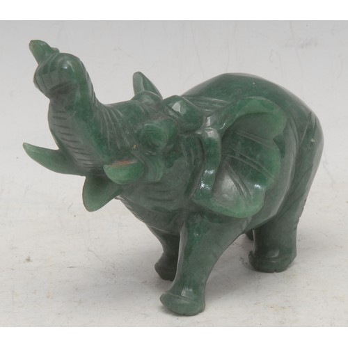 3629 - A carved composite jade elephant, trunk raised, 8.5cm high, 11cm long