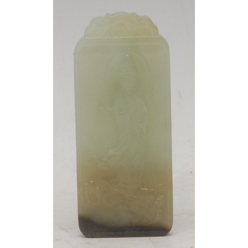 3059 - A Chinese jade tablet, carved in relief with Guanyin standing on a dragon, 8cm long