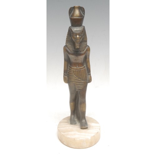 3570 - An Egyptian figural bronze, of King Ramses, onyx base, 25cm high overall; a composite cast, as a lio... 