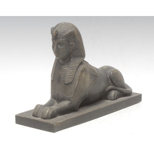 3048 - A bronzed metal figure, King Thutmosis III as a sphinx, after the Egyptian, rectangular base, 26cm l... 