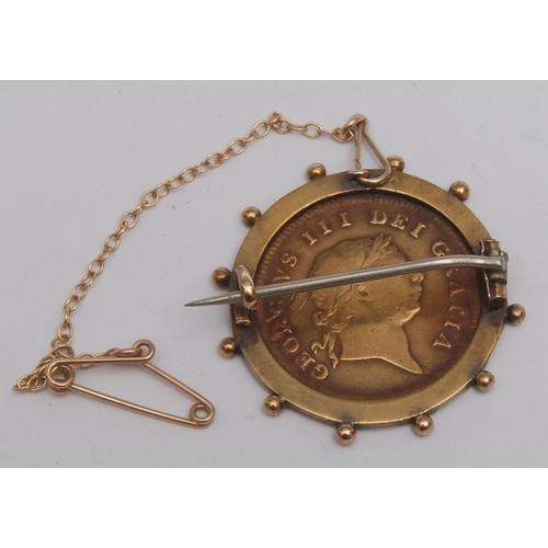 3874 - A George III 1806 half guinea, (garter type) gold coin, later mounted as a brooch, 2.6cm overall dia... 