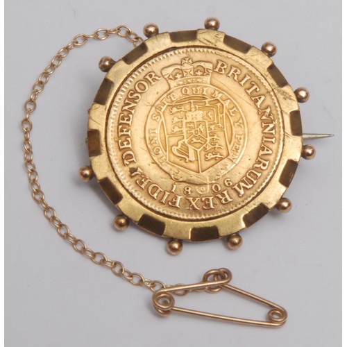 3874 - A George III 1806 half guinea, (garter type) gold coin, later mounted as a brooch, 2.6cm overall dia... 