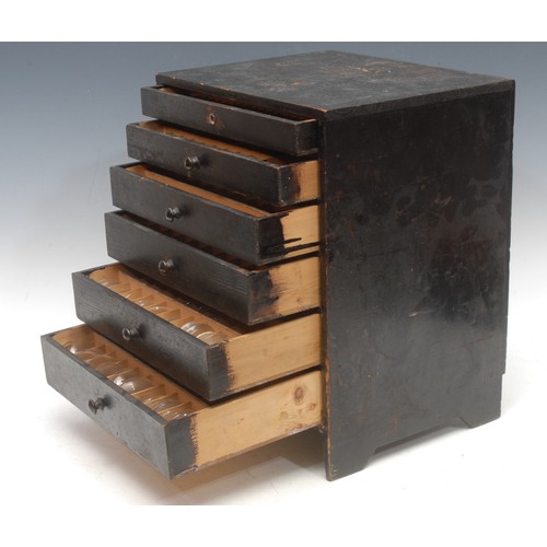 3723 - Horological Spares - a miniature table or workbench top black painted pine graduated six drawer ches... 