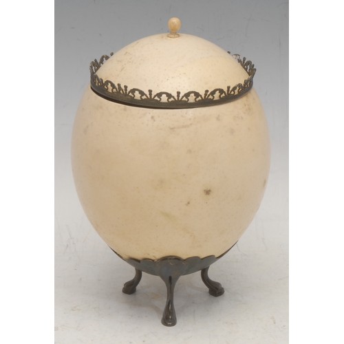 3468 - The Cabinet of Curiosities - an ostrich egg cup and cover, pad feet, 21cm high overall, early 20th c... 