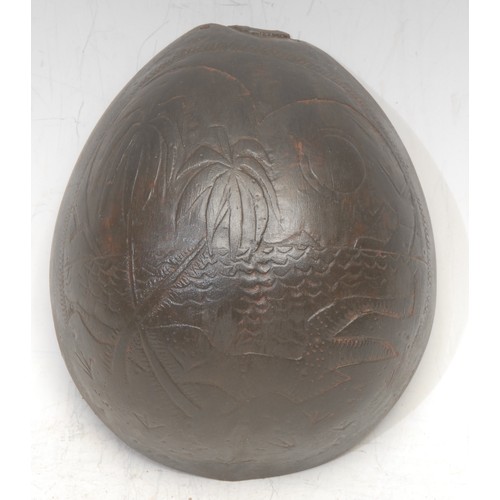 3620 - Folk Art & Treen - a Caribbean sailor's valentine type coconut shell, carved with a West Indian beac... 