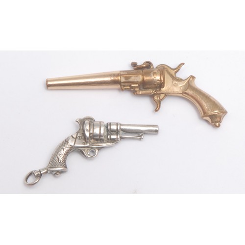 3721 - A novelty silver metal watch key, cast as a Revolver Pistol, 3.8cm long, unmarked, another gold plat... 