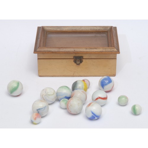 3064 - A collection of 19th century marbles, within a bjouterie box with glazed cover, 14cm wide