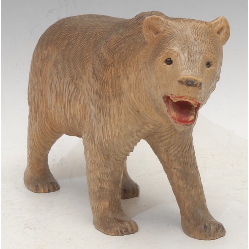 3037 - A Black Forest carving, of a bear, on all fours, painted features, 26cm long, early 20th century