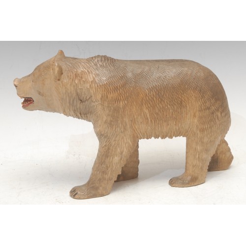 3037 - A Black Forest carving, of a bear, on all fours, painted features, 26cm long, early 20th century