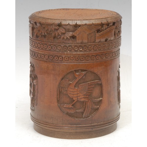 3051 - A Chinese bamboo cylindrical box and cover, carved in relief in the Cantonese taste with panels of f... 