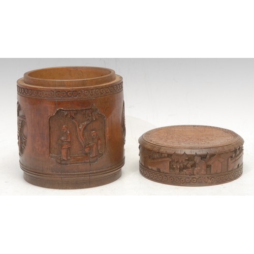 3051 - A Chinese bamboo cylindrical box and cover, carved in relief in the Cantonese taste with panels of f... 