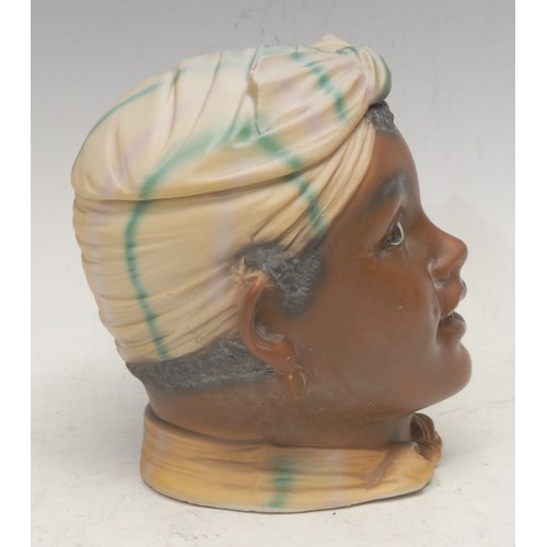 3093 - A German bisque porcelain novelty tobacco jar, as the head of a young Moorish girl, 14.5cm high, c.1... 