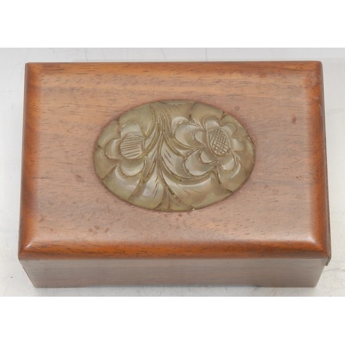 3058 - A Chinese hardwood box, the cover mounted with an oval jade panel carved with chrysanthemums, 13cm w... 