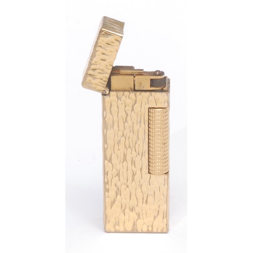 3077 - A Dunhill Rollagas cigarette lighter, gold plated bark-textured case, 6.5cm long