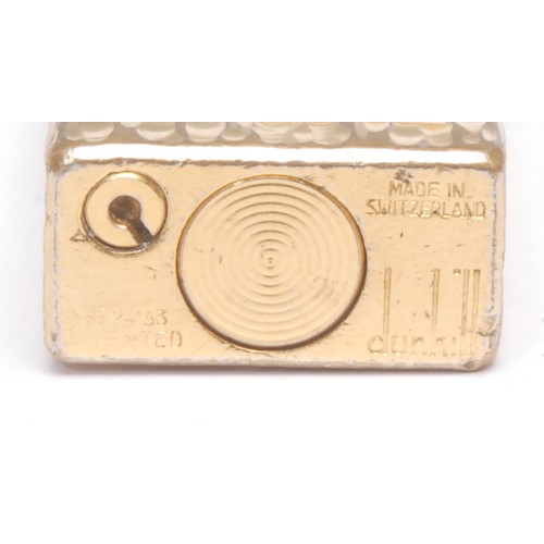 3077 - A Dunhill Rollagas cigarette lighter, gold plated bark-textured case, 6.5cm long