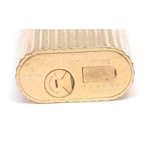 3049 - A Cartier gold plated cigarette lighter,serial no. 105048, 7cm long, boxed