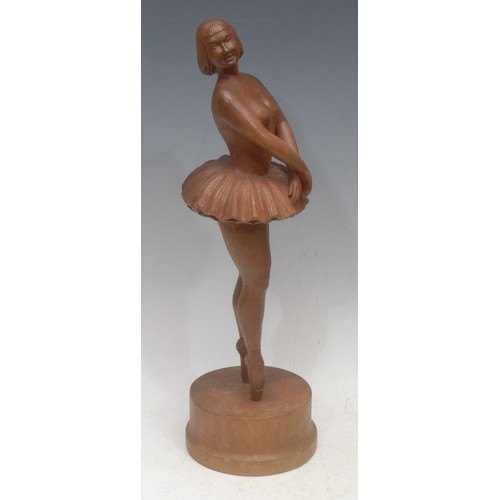 3035 - A 20th century French carved treen sculpture of a ballerina en pointe in tutu, bobbed hair, demure p... 