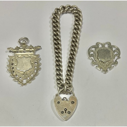 756 - A Silver Curb Link Bracelet with Heart Shaped Padlock and two Silver Watch Fobs; the bracelet is ind... 