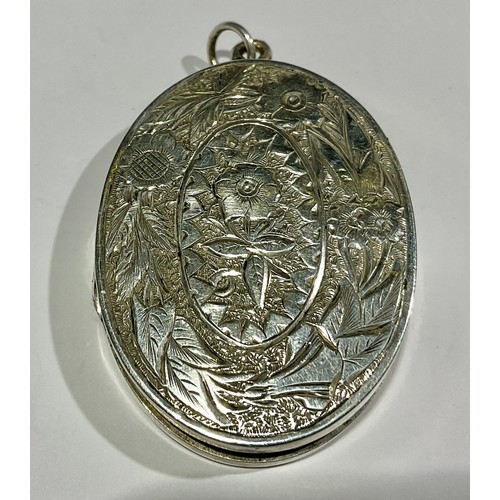 760 - A Tested Silver Oval Locket and two Unmarked White Metal Horseshoe Design Buckles; the locket measur... 