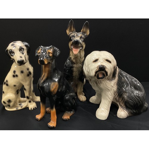 70 - A group of large ceramics dogs, including; German Shepherd, 49cm high, Dalmatian, 40cm high, Old Eng... 