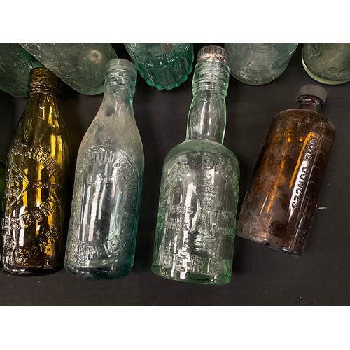 79 - A collection of 19th and 20th century glass codd and other collectible bottles, including;  Whittake... 