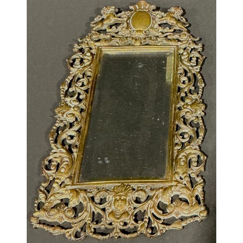 62 - A 19th century Baroque style shaped rectangular looking glass, the brass frame cast with foliate scr... 