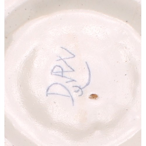 159 - A Delft lobed circular dish, painted in polychrome, with a peacock in a garden setting, the rim with... 