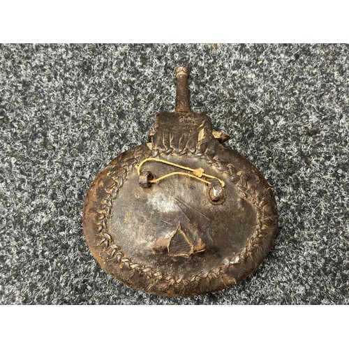 5337 - Persian Powder Flask. Tooled leather covered wooden body. Metal spout and suspension loops. 145mm in... 