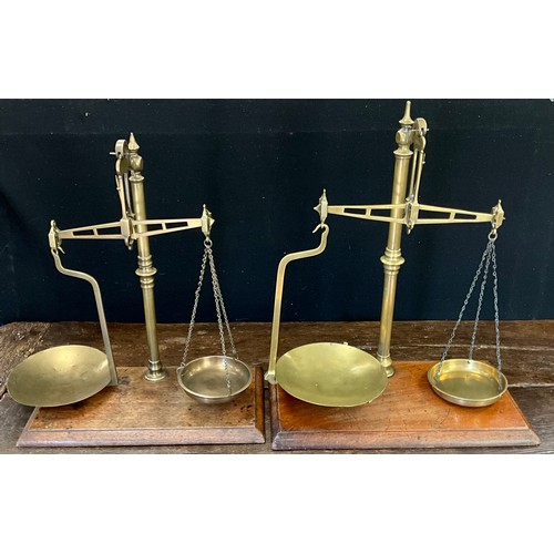 204 - A set of W & T Avery brass 12oz weighing scales, mahogany base;  another similar, W A Webb, London, ... 