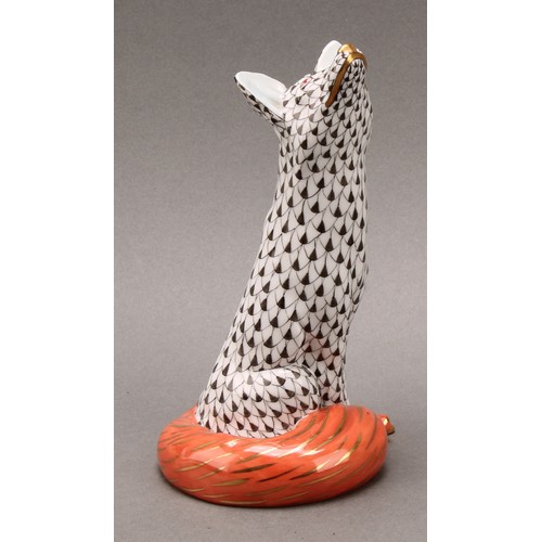 4068 - A Herend porcelain model, of a seated fox, painted in black fishnet pattern, orange tail, picked out... 