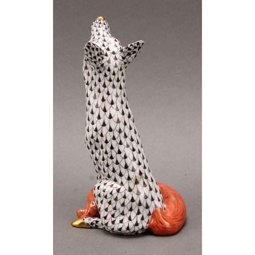 4068 - A Herend porcelain model, of a seated fox, painted in black fishnet pattern, orange tail, picked out... 