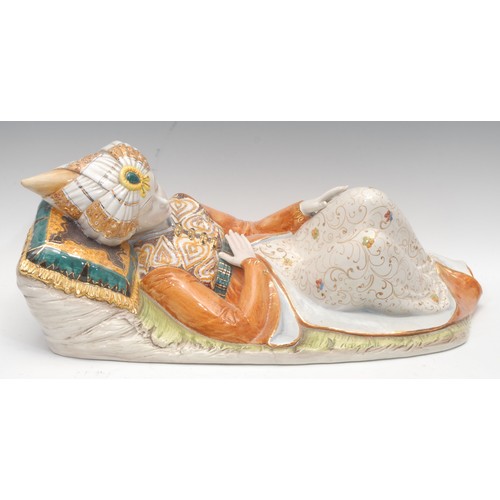 4072 - A large Italian faience figure, after D. Polo Uiato, of a reclining boy, wearing traditional Morocca... 