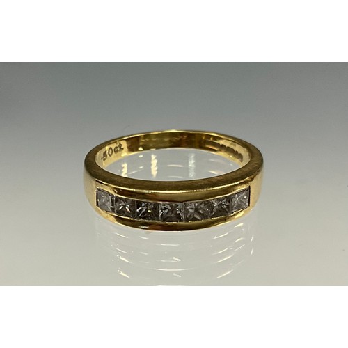 6240 - An 18ct gold princess cut diamond eternity ring set with seven princess cut diamonds, total diamond ... 