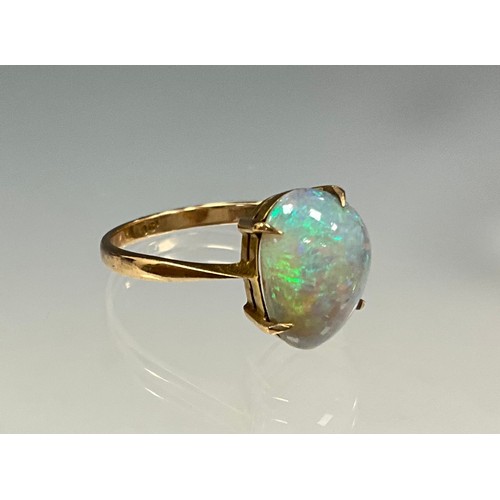 6276 - An opal cabochon ring, free form opal with vibrant blue green and red colour play, 9ct gold shank, s... 