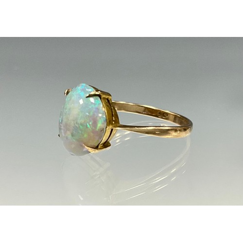 6276 - An opal cabochon ring, free form opal with vibrant blue green and red colour play, 9ct gold shank, s... 