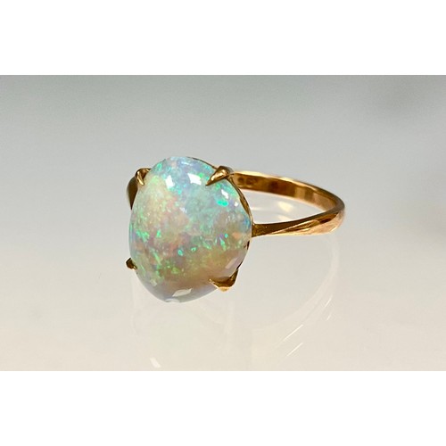 6276 - An opal cabochon ring, free form opal with vibrant blue green and red colour play, 9ct gold shank, s... 