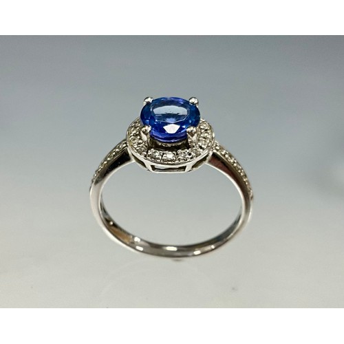 6255 - An 18ct white gold Iliana tanzanite and diamond ring, set with a round brilliant cut light bluish-pu... 