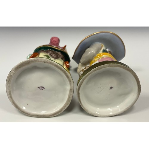 6307 - A pair of Royal Crown Derby style Mansion House Dwarfs, decorated in typical fashion, 13cm, and 14cm... 