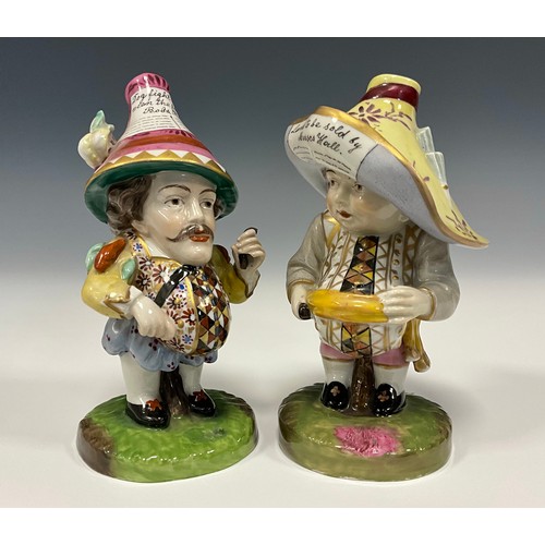6307 - A pair of Royal Crown Derby style Mansion House Dwarfs, decorated in typical fashion, 13cm, and 14cm... 