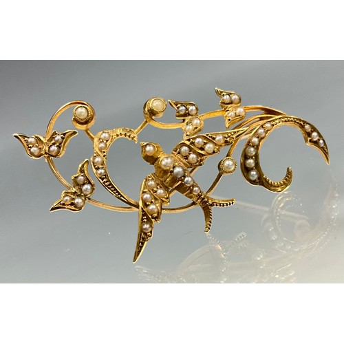 6269 - An Edwardian 15ct gold swallow split seed pearl brooch, swallow and scrolling foliate motif, set wit... 