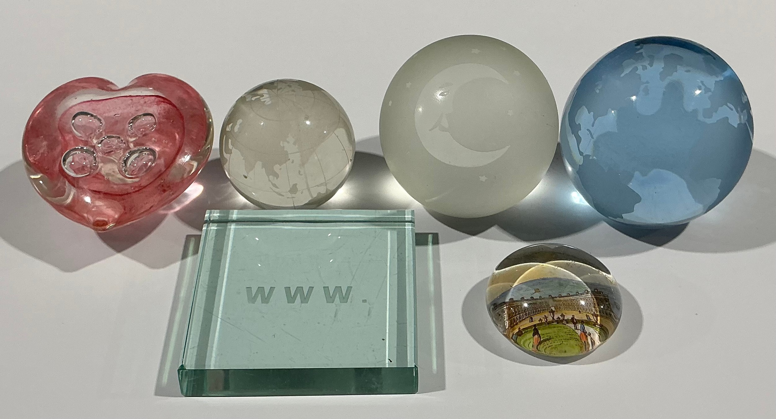Novelty paperweights; two engraved as terrestrial globes, one with moon ...