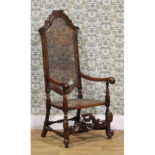 425 - A William & Mary Revival walnut armchair, shaped cresting, scroll hand rests, shaped front stretcher... 