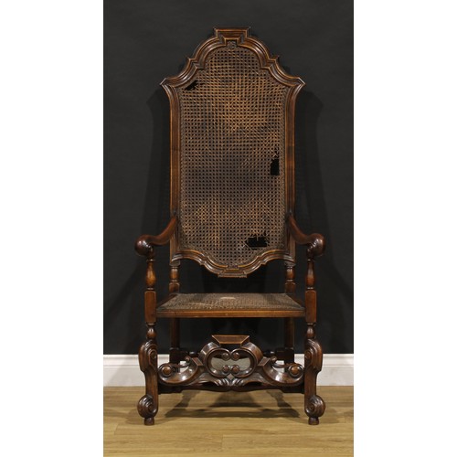 425 - A William & Mary Revival walnut armchair, shaped cresting, scroll hand rests, shaped front stretcher... 