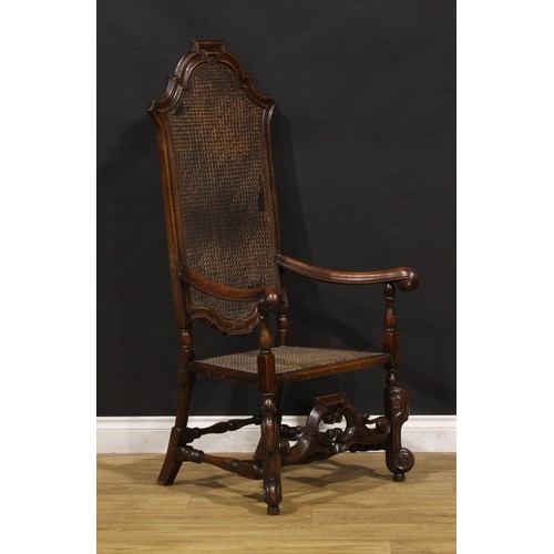 425 - A William & Mary Revival walnut armchair, shaped cresting, scroll hand rests, shaped front stretcher... 