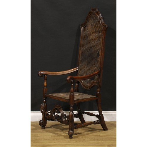 425 - A William & Mary Revival walnut armchair, shaped cresting, scroll hand rests, shaped front stretcher... 